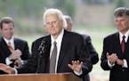 May 31, 2007: Billy Graham speaks as his son Franklin Graham, right, listens during a dedication ceremony for the Billy Graham Library in Charlotte, N