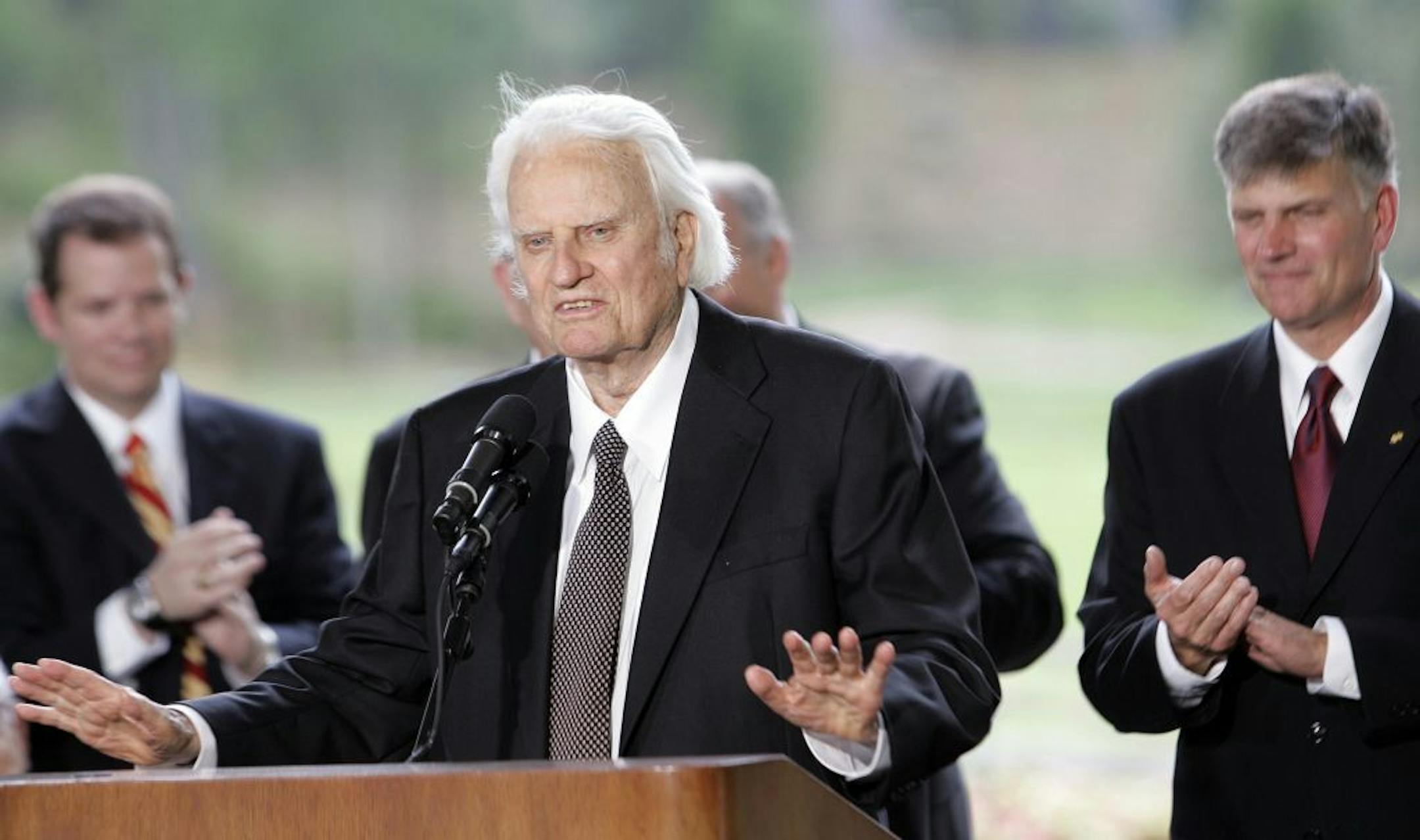 May 31, 2007: Billy Graham speaks as his son Franklin Graham, right, listens during a dedication ceremony for the Billy Graham Library in Charlotte, N.C..