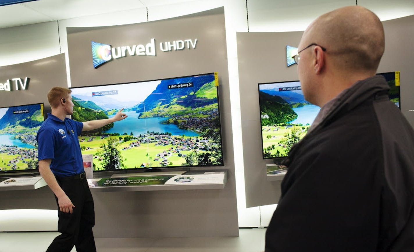 At the Best Buy store in Minnetonka, 4k televisions. They were all the buzz of the Consumer Electronics Show and will likely be a big selling point during the Super Bowl TV buying spree. Sales person Rhett Bjork was pointing out the finer points of the Samsung UHD set to vendor Andrew Kestly. ] Richard Tsong-Taatatarii@startribune.com