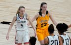 Paige Bueckers (5) played against Caitlin Clark (22) when UConn defeated Iowa 92-72 in the 2021 Sweet 16 in San Antonio.