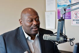 Walter "Q Bear" Banks Jr. on the air on KMOJ radio.