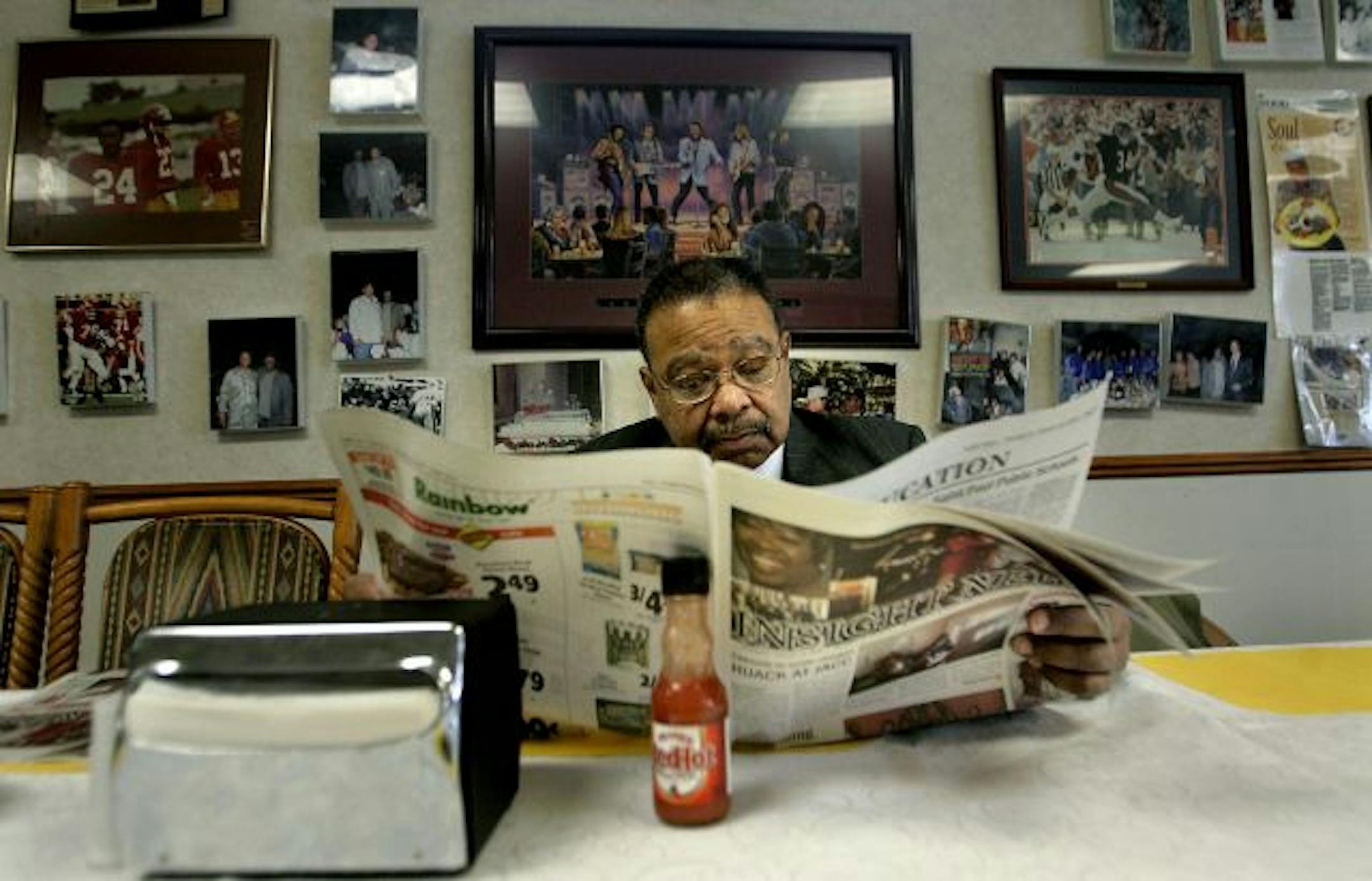 Northside businessman Larry Tucker looked over Insight News before breakfast at Minneapolis' Sunnyside Up Cafe. Tucker is a regular at weekly community meetings with Insight news publisher Al McFarlane, where topics include the economy, the current foreclosure problems, contracts and race.