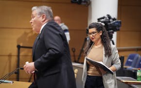 Sen. Glenn Gruenhagen, left, prepares to sit in the Senate hearing room before addressing the ethics complaint brought against him by Sen. Erin Maye Q