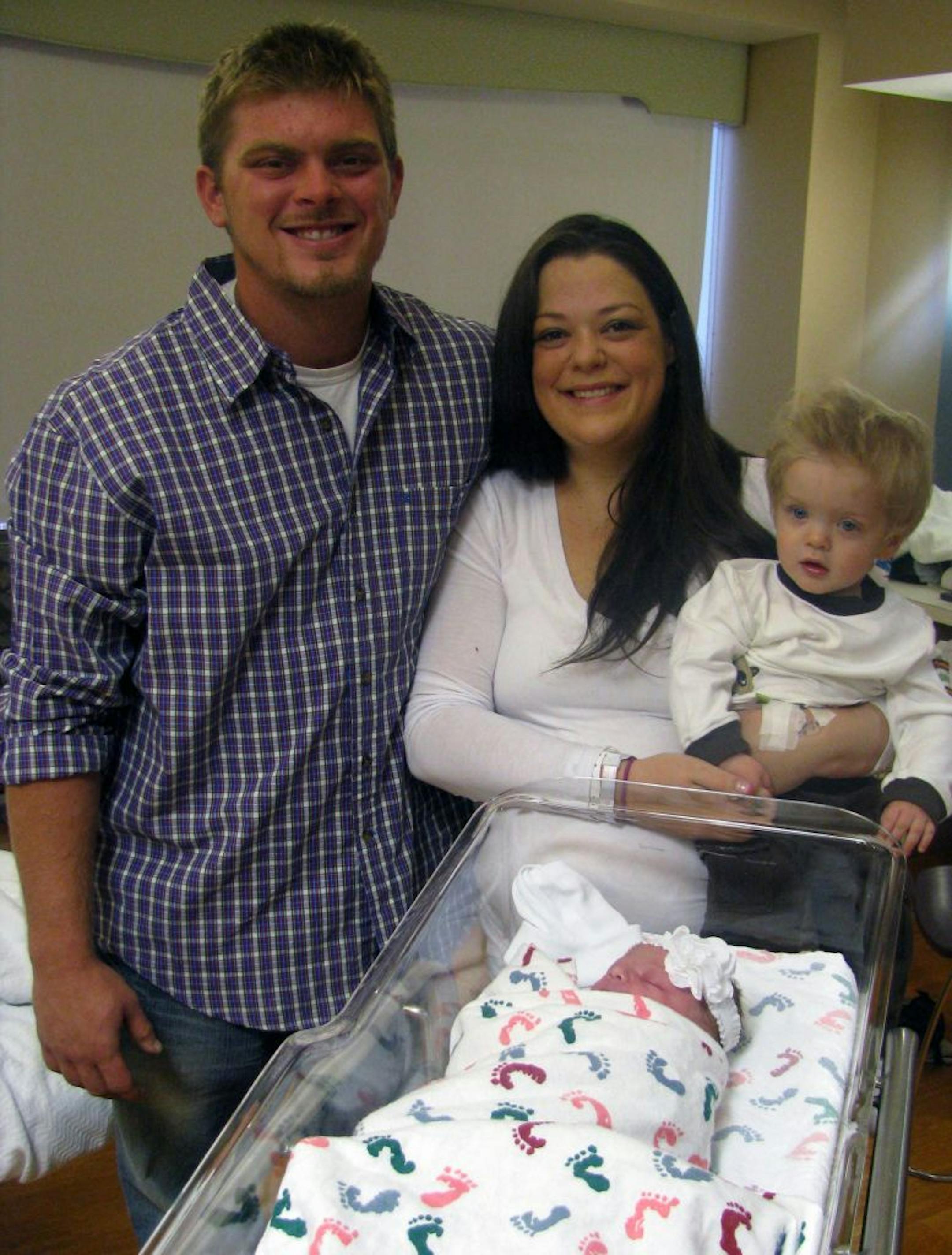 From left, Ryan Fitzgerald, Katie Deremiah, and their son, Jackson pose for a photograph in front of their daughter, Laila, at Iowa Methodist Medical Center Thursday, Oct. 11, 2012. The Des Moines Register reports that Laila weighed 8 pounds, 9 ounces. She came into the world on Thursday, which, numerically speaking, was 10/11/12. She arrived, militarily speaking, at 1314, which would be 1:14 p.m. for civilians. So the numbers associated with her birth are 8-9-10-11-12-13-14. (AP Photo/The Des M