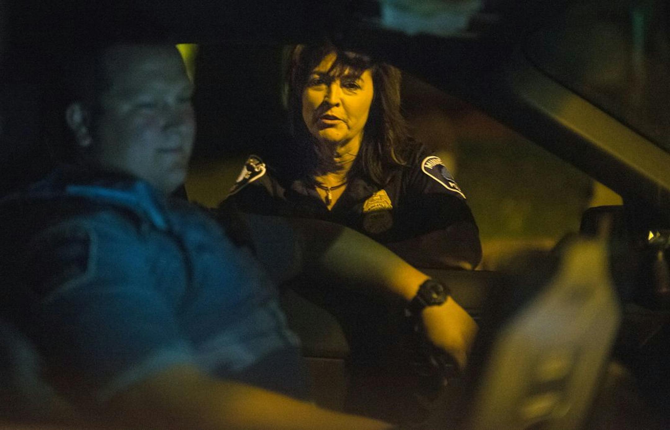 On the 1800 Newton Ave N. block where a homicide occurred, Minneapolis police chief Janee Harteau checked in with a Park Police officer.