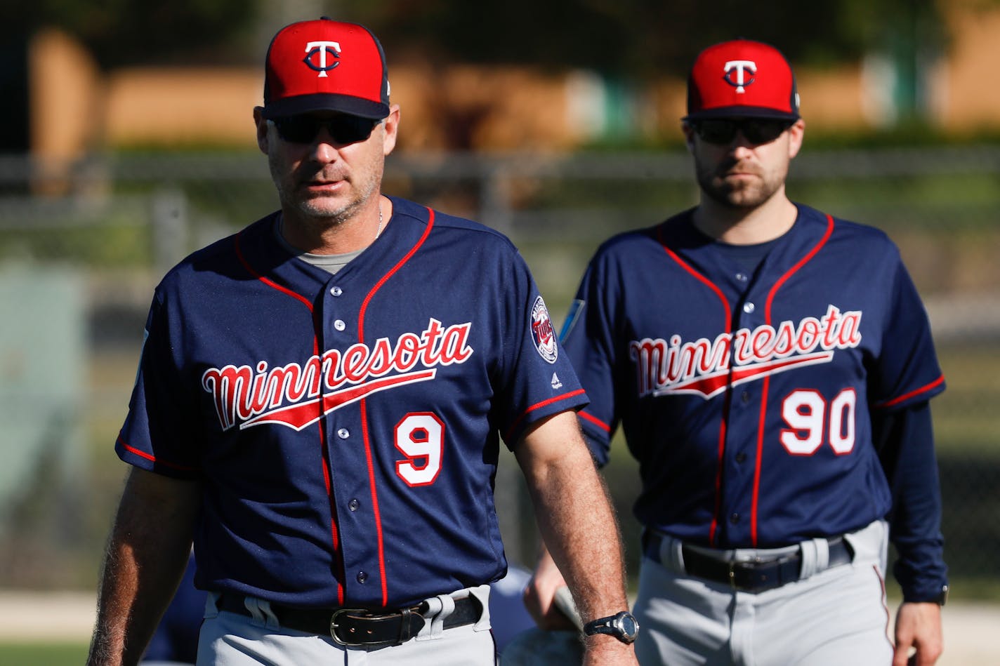 Minnesota Twins bench coach Derek Shelton walks the field before practice during baseball spring training, Saturday, Feb. 17, 2018, in Fort Myers, Fla. (AP Photo/John Minchillo)