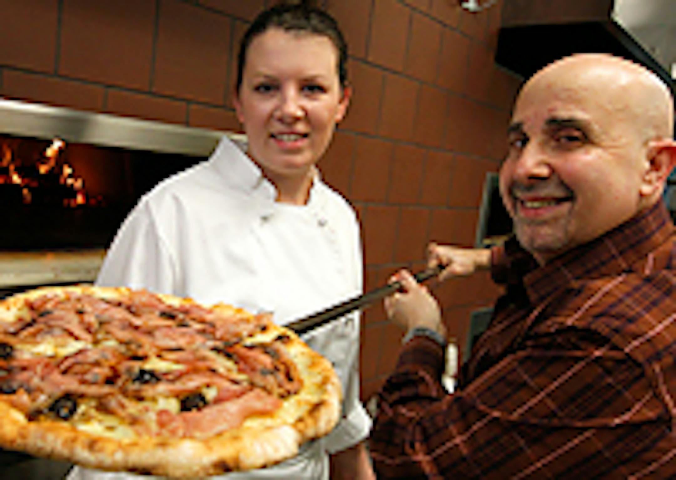 Executive chef Heather Brinker and consulting chef Vittorio Renda with a fig, prosciutto and caramelized onion pizza.