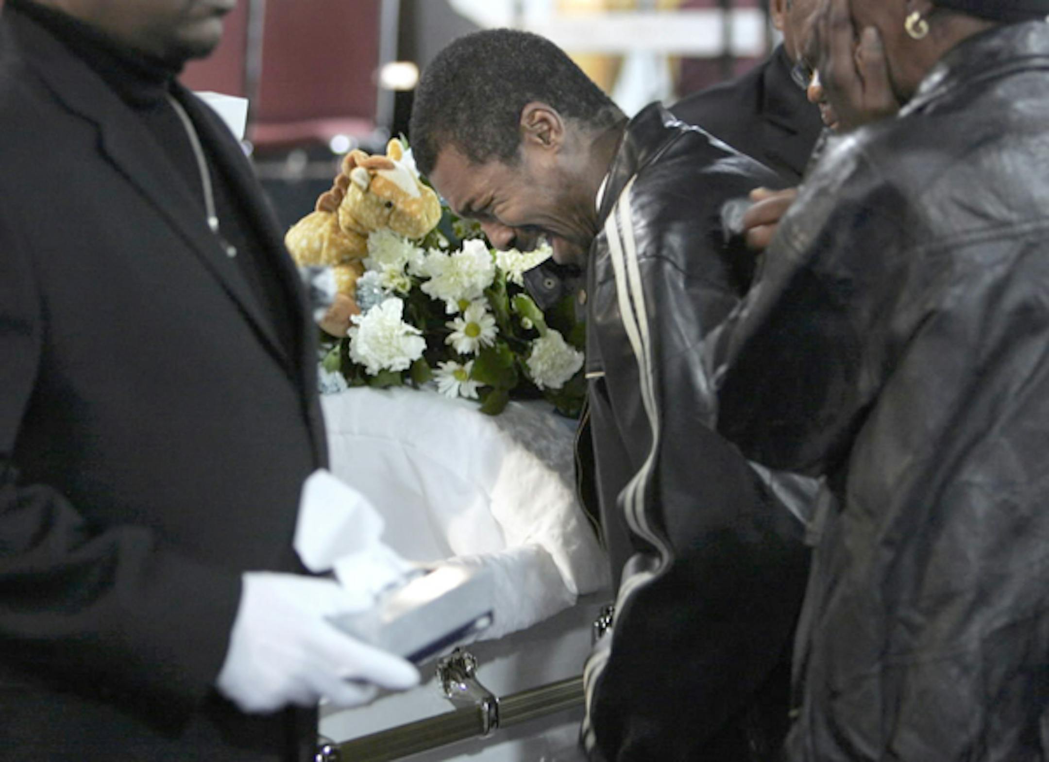 Tony Ishmon, 39, the grandfather of Demond Reed, wept into the open casket at Shiloh Temple in Minneapolis on Monday night. When Ishmon broke down, he was ushered out of the sanctuary. Before the service, he said he was still shocked by his grandson's death. "It just doesn't seem real," he said.