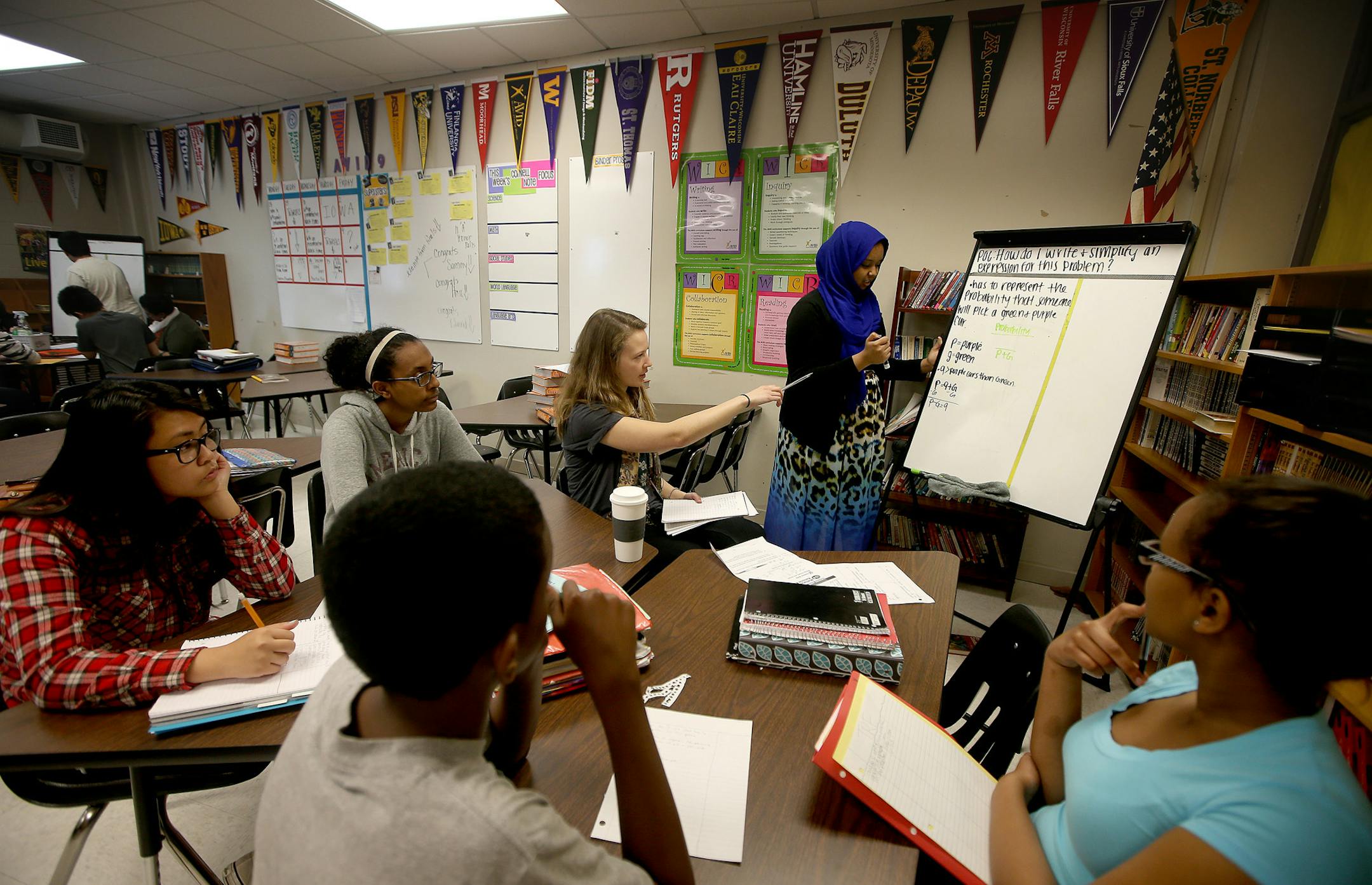Advancement Via Individual Determination (AVID) tutor Eva Carlson, center, worked with students at Joseph Nicollet Junior High School, Tuesday, May 20, 2014 in Burnsville, MN. Carlson is a Biomedical Engineering student at the University of Minnesota. ] (ELIZABETH FLORES/STAR TRIBUNE) ELIZABETH FLORES &#x2022; eflores@startribune.com