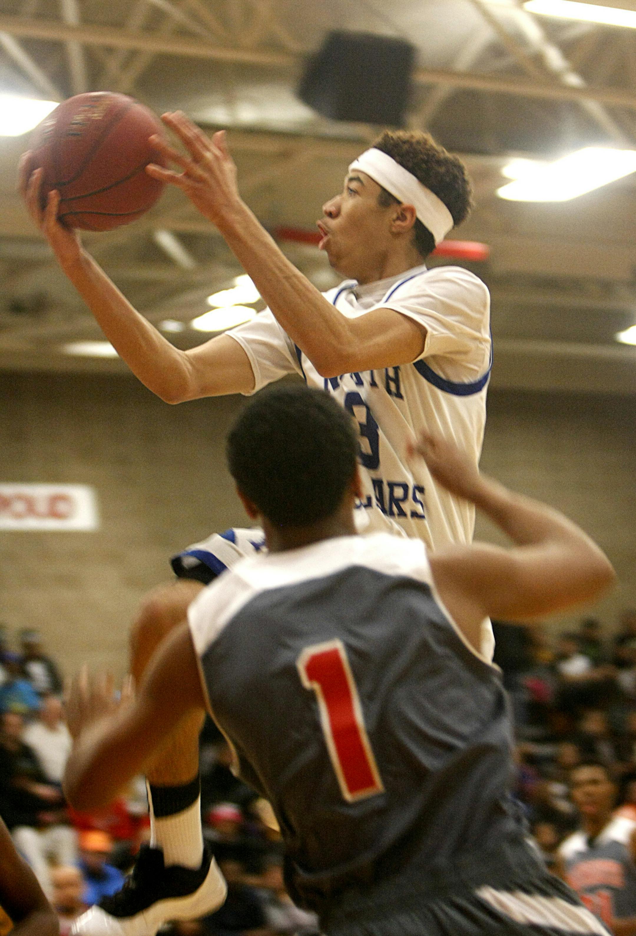 Minneapolis North forward Jamil Jackson takes the ball to the hoop past Minneapolis Henry guard Stephen Kennedy during the first half of the Polars 83-70 victory at Henry on Friday, January 10. ] Chris Kelleher, Special to the Star Tribune, 1/10/2014, Minneapolis, Minn.