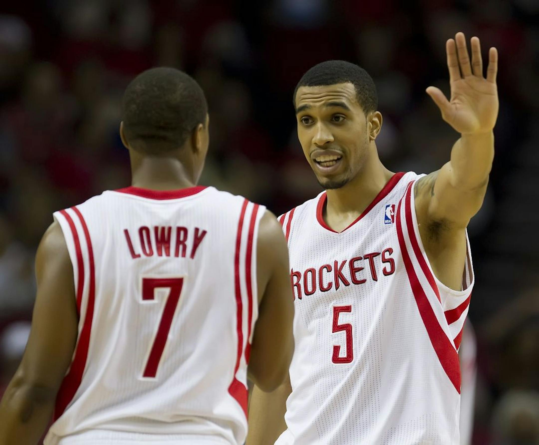 Courtney Lee (5) of the Houston Rockets talks with teammate Kyle Lowry (7) during a break in the action against the Memphis Grizzlies in the first half on Monday, February 20, 2012, in Houston, Texas.