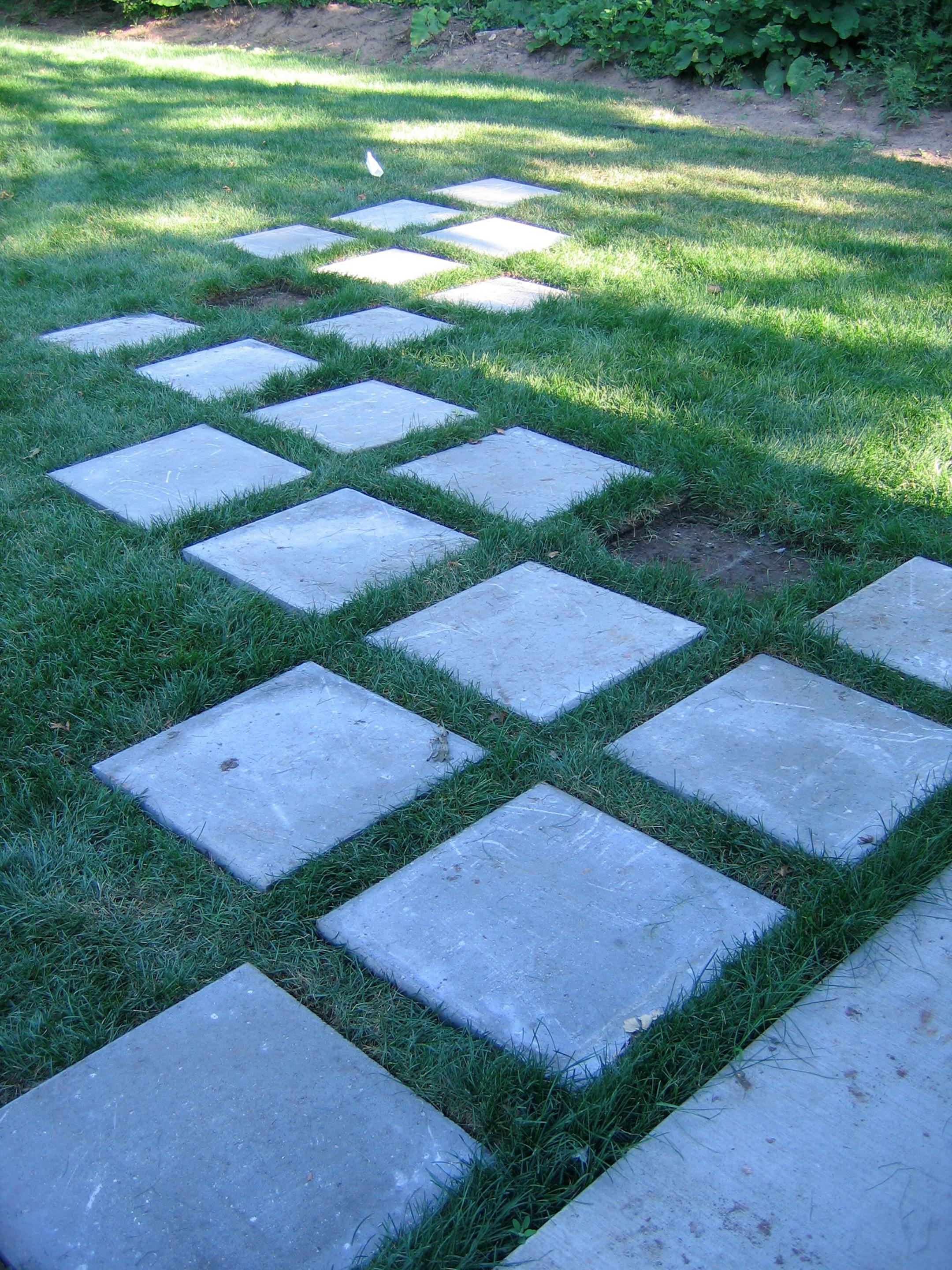 Concrete pavers create a path from the Hammonds' house to outlying spaces on the lot, including the play area.
