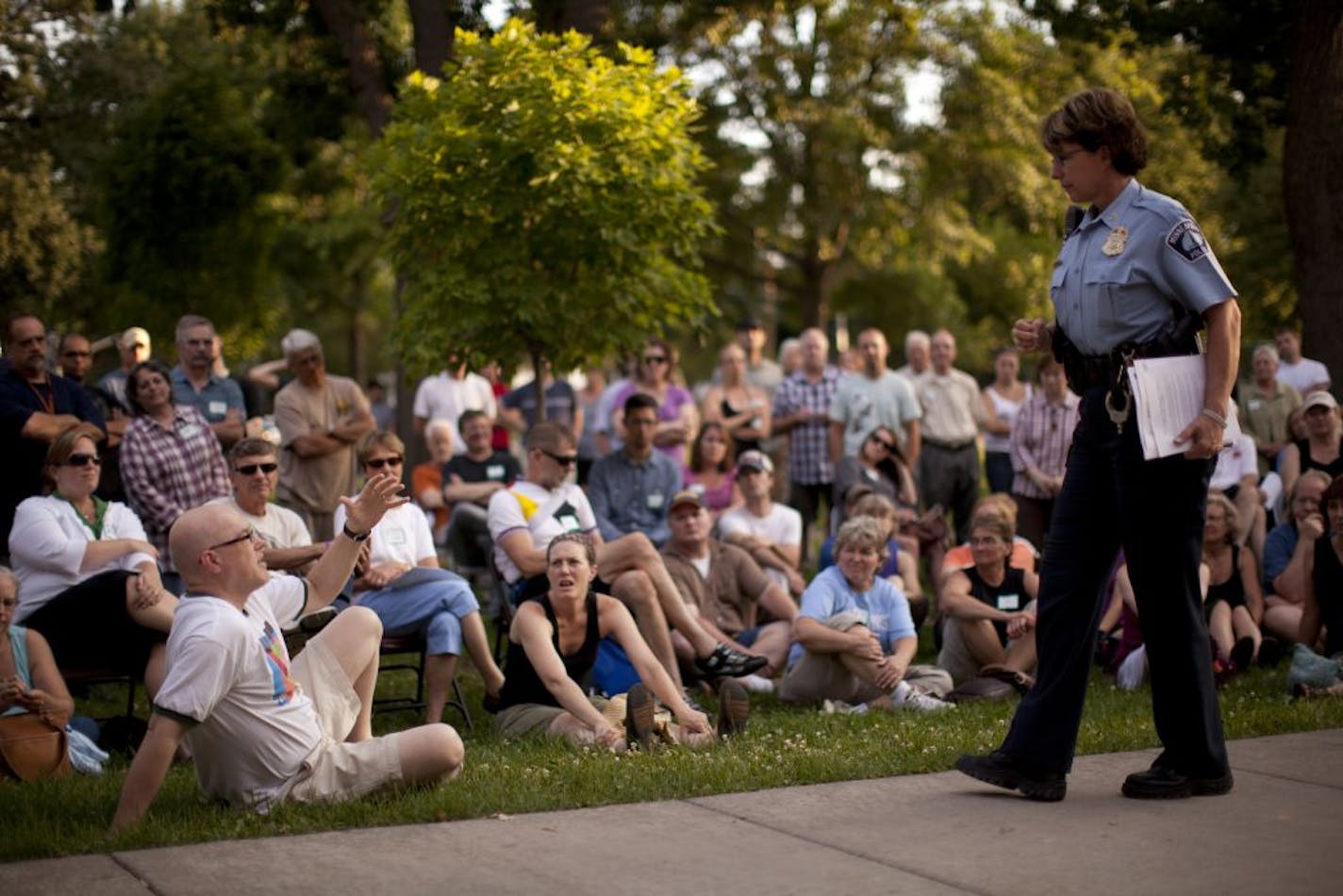 Minneapolis police Inspector Lucy Gerold listened to a question from Mike Miller, left, at a community meeting Tuesday about Shea Stremcha's slaying.