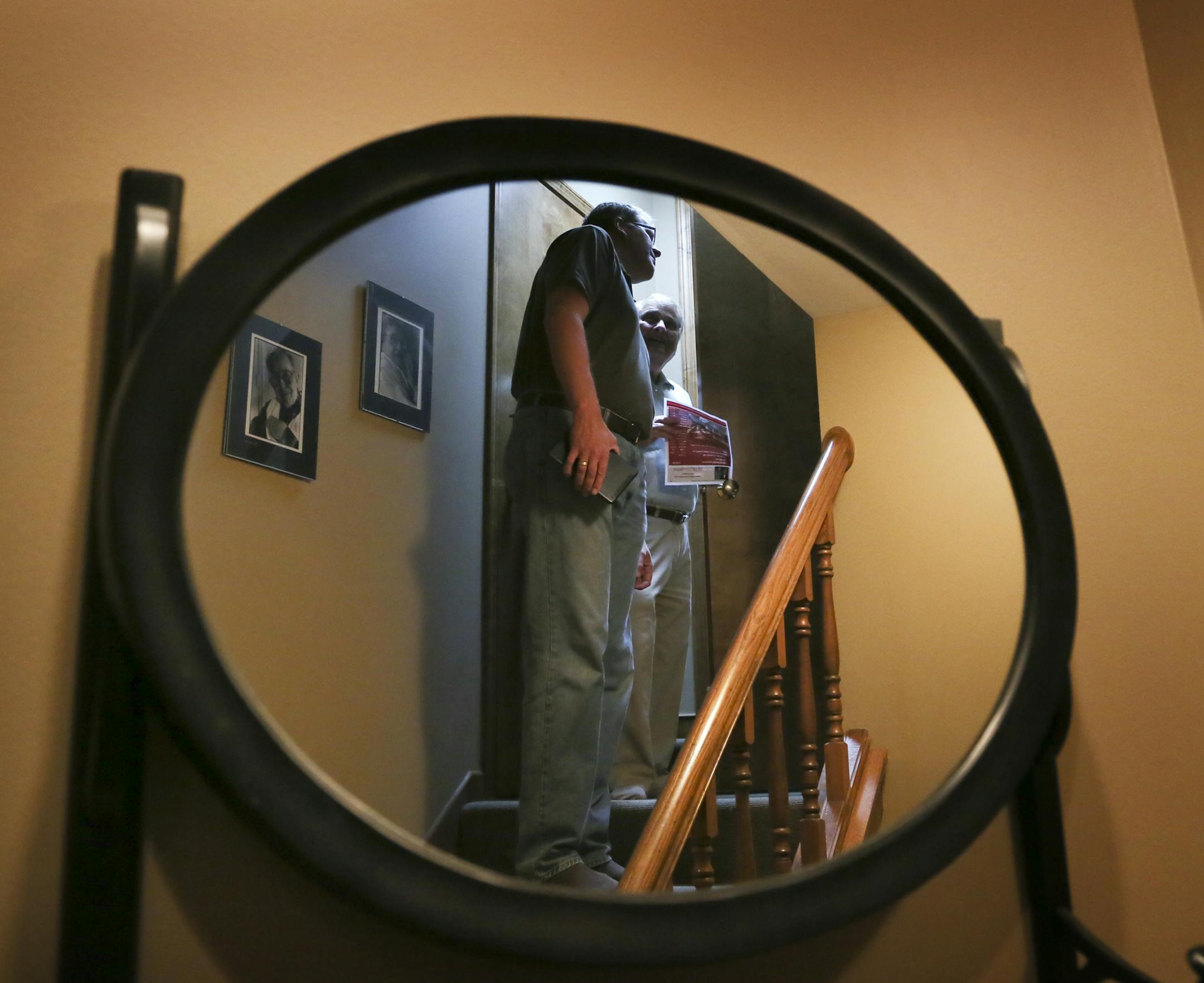 Prospective home buyer Stephen Blatnik, left, and his realtor Herb Bacal of Counselor Realty are reflected in a mirror while touring a four bedroom, four bath home in Edina overlooking Mirror Lake at a realtor's open house Tuesday, Sept. 17, 2013, in Edina, MN. The home was on the market for $999,900. "For under a million (dollars) it's a great buy," Meg Meyers, Edina Realty realtor senior analyst, who represented the sellers, had said earlier in the day.](DAVID JOLES/STARTRIBUNE) djoles@startri