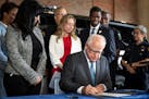 Gov. Tim Walz signed a bill toughening penalties for “straw” purchases of guns, along with a ban on binary triggers, on June, 3, 2024.