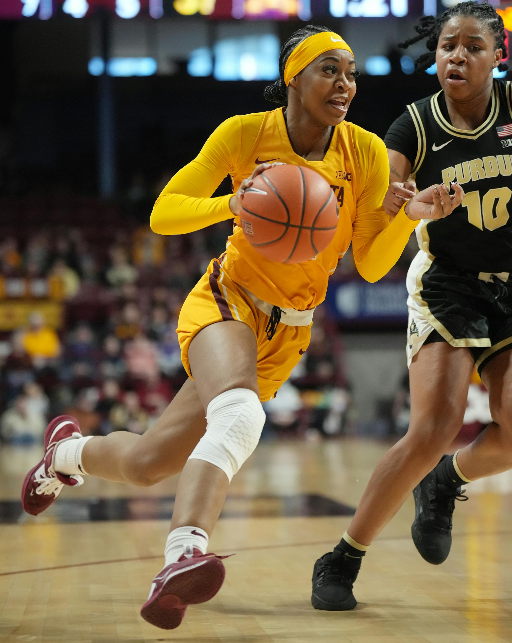 Minnesota Gophers' Mi'Cole Cayton (21) drives against Purdue guard Jeanae Terry (10).