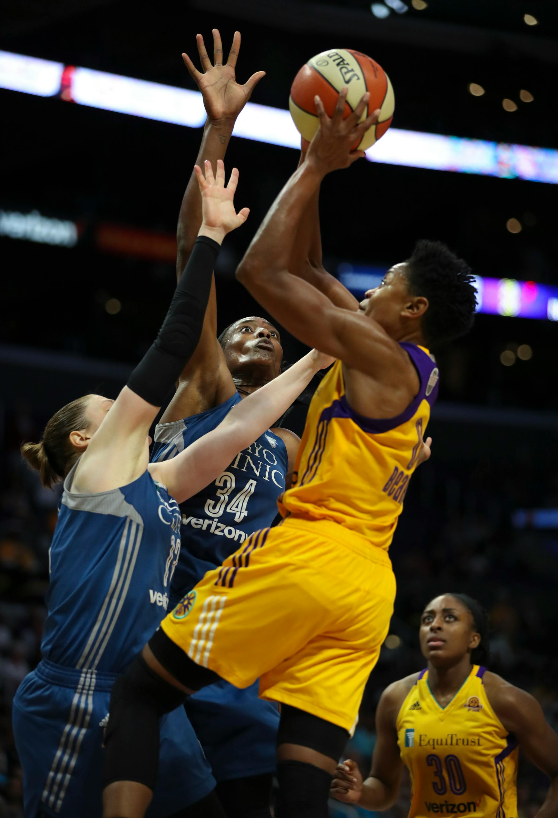 Minnesota Lynx center Sylvia Fowles (34) fouled Los Angeles Sparks guard Alana Beard (0) as she and Lynx guard Lindsay Whalen (13) defended her in the fourth quarter.
