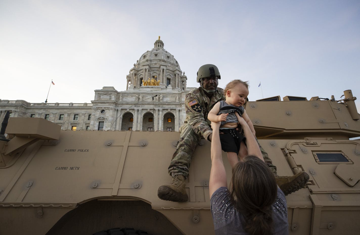 Natasha Robinson passed her son Azrael Hammick, 1, up to Master Sergeant Acie Matthews jr. during a protest at the at the Minnesota State Capitol in St. Paul. ] CARLOS GONZALEZ • cgonzalez@startribune.com – Minneapolis, MN – June 1, 2020, Police Protest - man died after a confrontation with Minneapolis on Monday evening. A bystander video that started circulating sometime after the incident appeared to show the man pleading with officers that he couldn't breathe - George Floyd