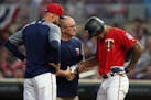 Minnesota Twins center fielder Byron Buxton (25) was checked by trainers after he was hit in the hand while batting in the sixth inning.