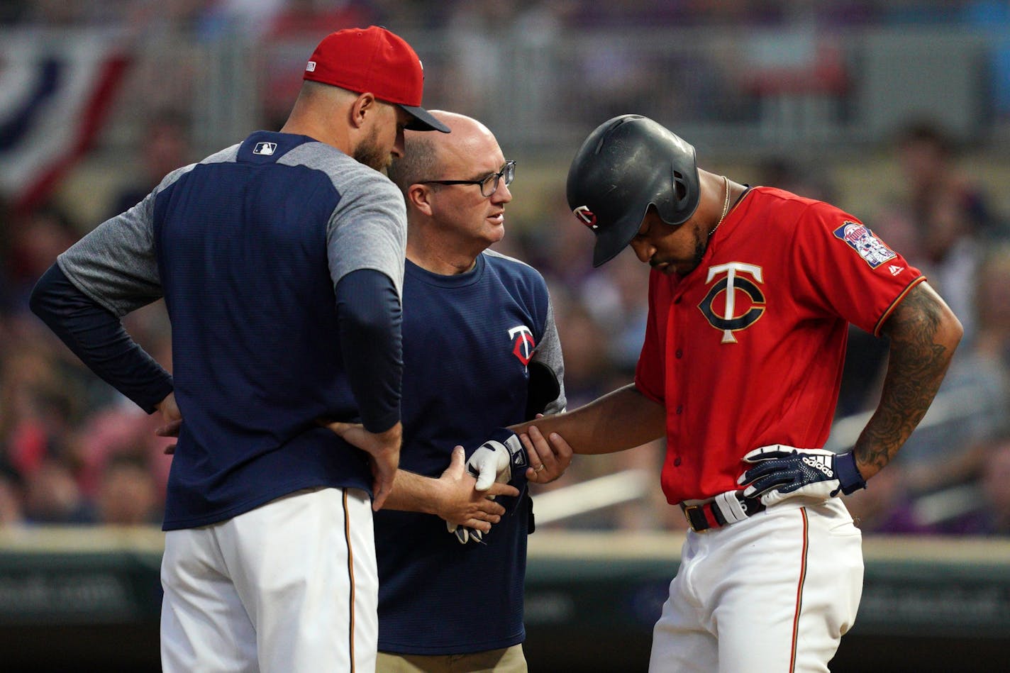 Minnesota Twins center fielder Byron Buxton (25) was checked by trainers after he was hit in the hand while batting in the sixth inning.