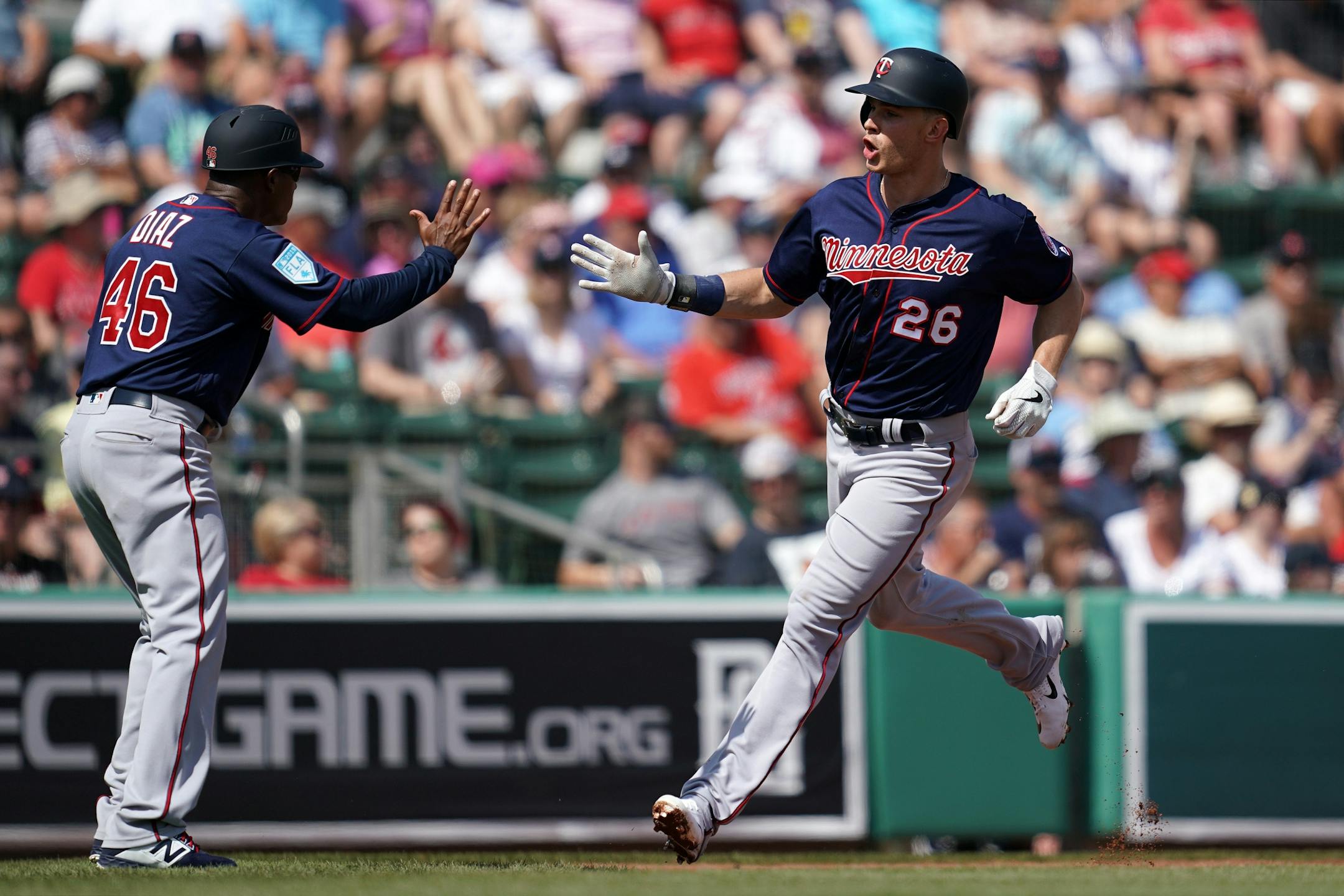Minnesota Twins right fielder Max Kepler (26) celebrated with Minnesota Twins third base coach Tony Diaz (46) after he hit a second home run in his second at bat during Sunday's game.