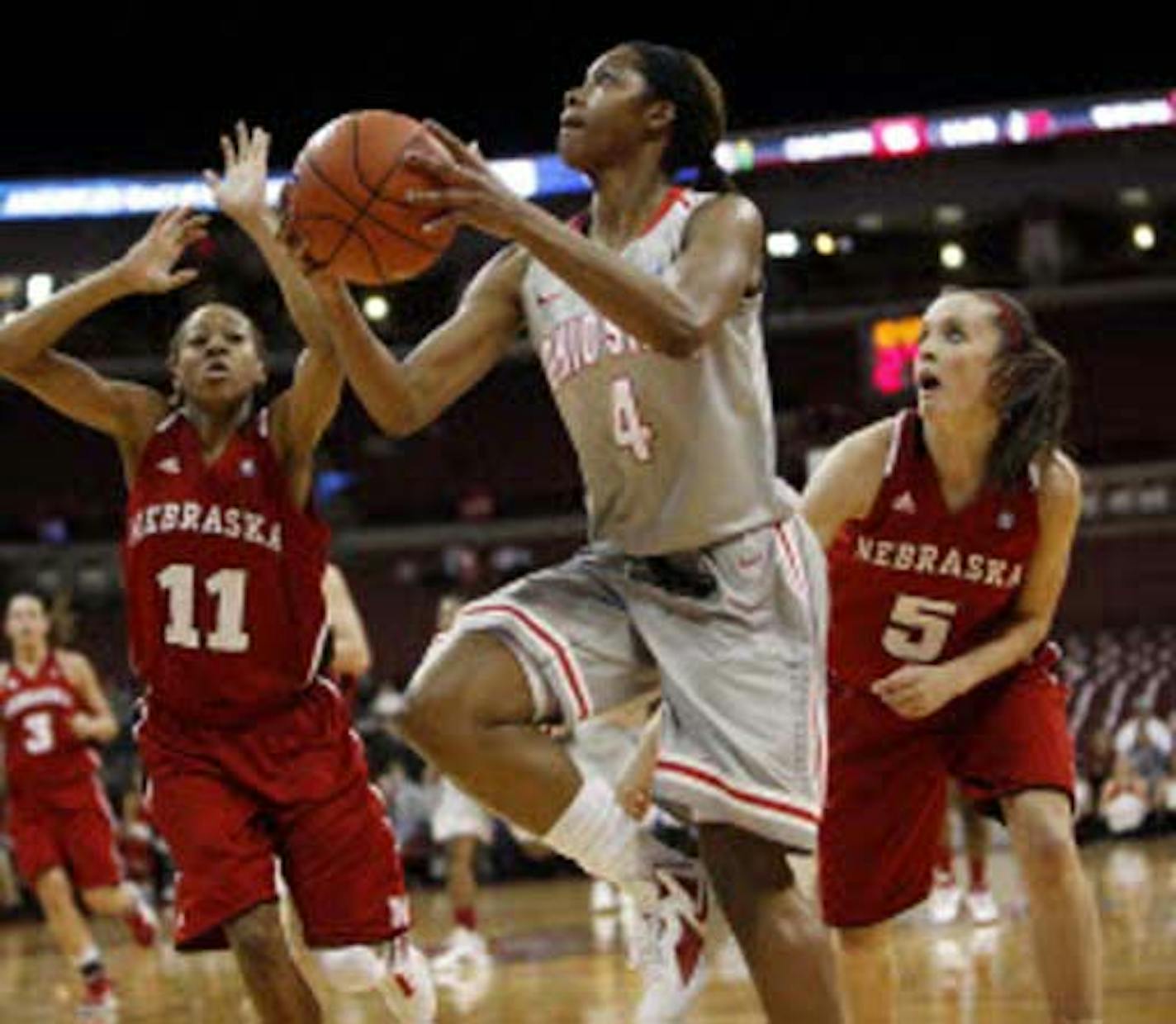 Ohio State's Tayler Hill (4) drove to the basket as Nebraska's Meghin Williams (11) and Kaitlyn Burke (5) defended during the first half Thursday. Hill, a former Minneapolis South star, scored 21 points to lead the No. 10 Buckeyes over the Cornhuskers 82-68.