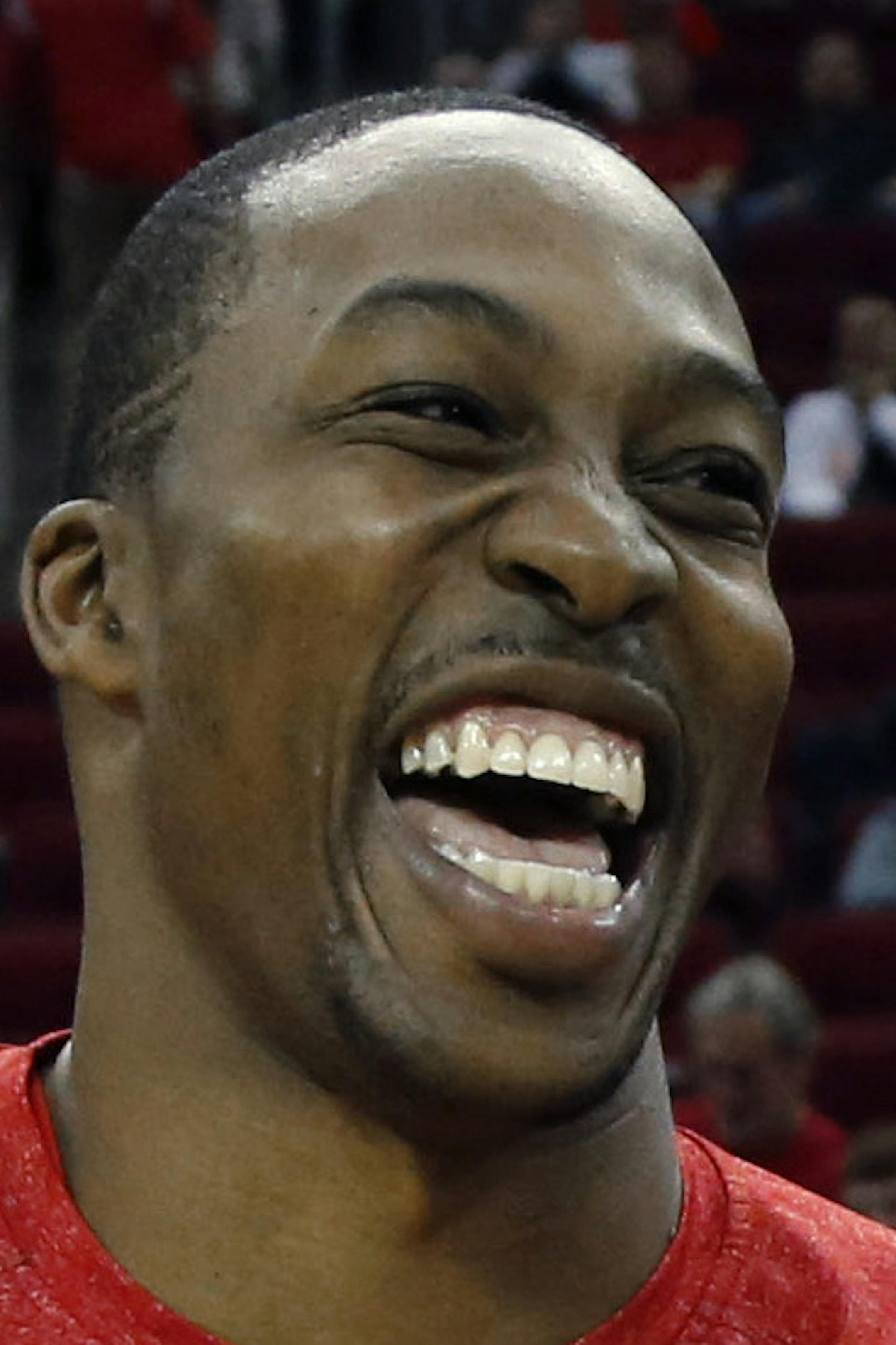 Houston Rockets' Dwight Howard, left, laughs as he talks with Los Angeles Lakers' Jodie Meeks, right, before an NBA basketball game Thursday, Nov. 7, 2013, in Houston. (AP Photo/David J. Phillip)