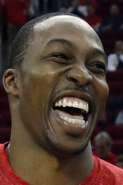 Houston Rockets' Dwight Howard, left, laughs as he talks with Los Angeles Lakers' Jodie Meeks, right, before an NBA basketball game Thursday, Nov. 7, 