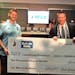 Minnesota United goalkeeper Matt Lampson (left) received a $10,000 check on behalf of his foundation from Bell Bank President Michael Solberg.