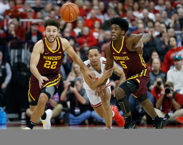 Ohio State's C.J. Walker, center, Minnesota's Gabe Kalscheur, left, and Marcus Carr chase a loose ball during the first half in January.