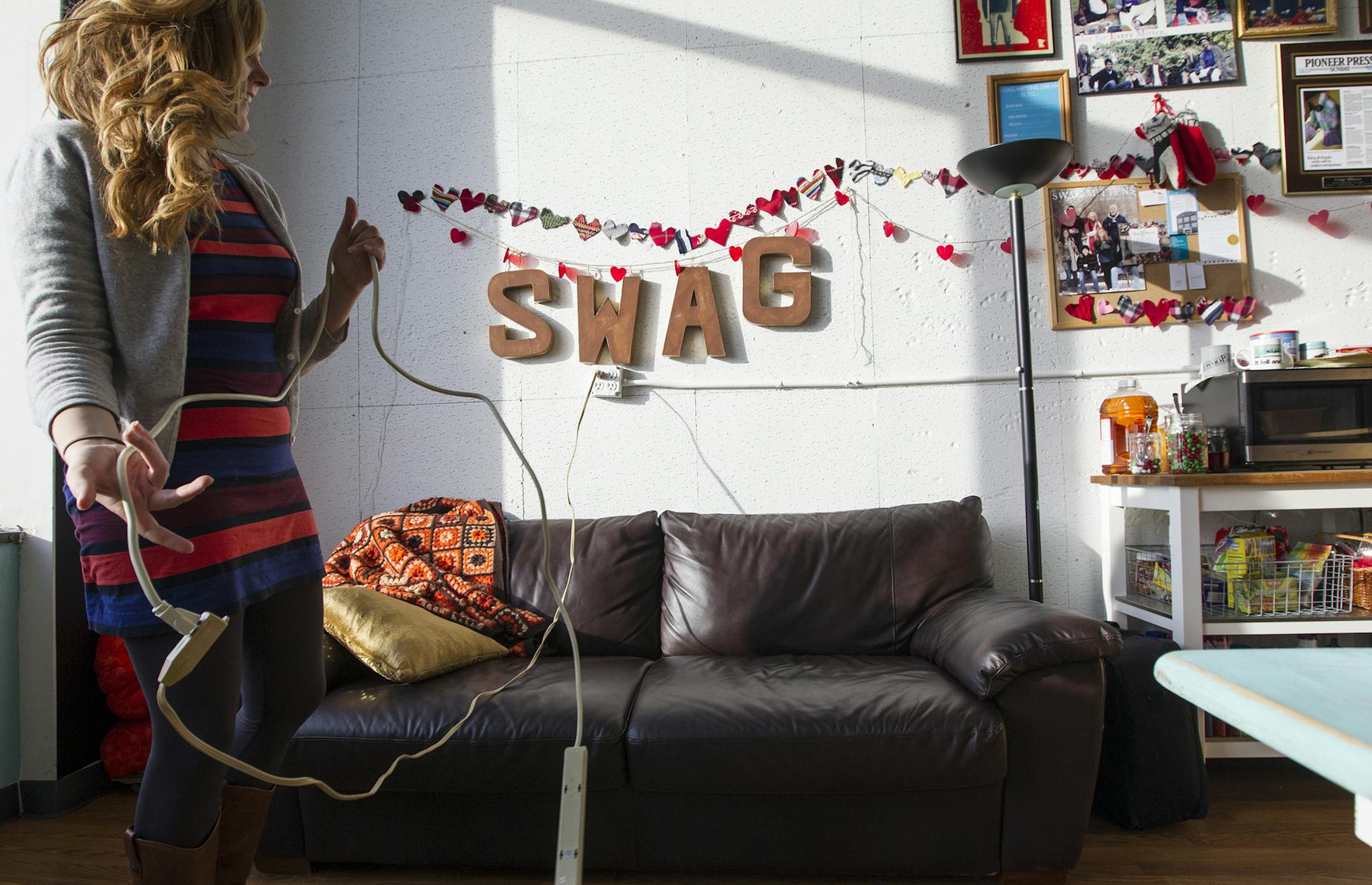 Sarah Vandelist sews mittens in her St. Paul studio December 23, 2013. (Courtney Perry/Special to the Star Tribune) ] A Macalester student and Lakeville North graduate, Vandelist started a business while in high school creating mittens from old sweaters. Years later, she has her own studio and a thriving business called Swag Mittens.