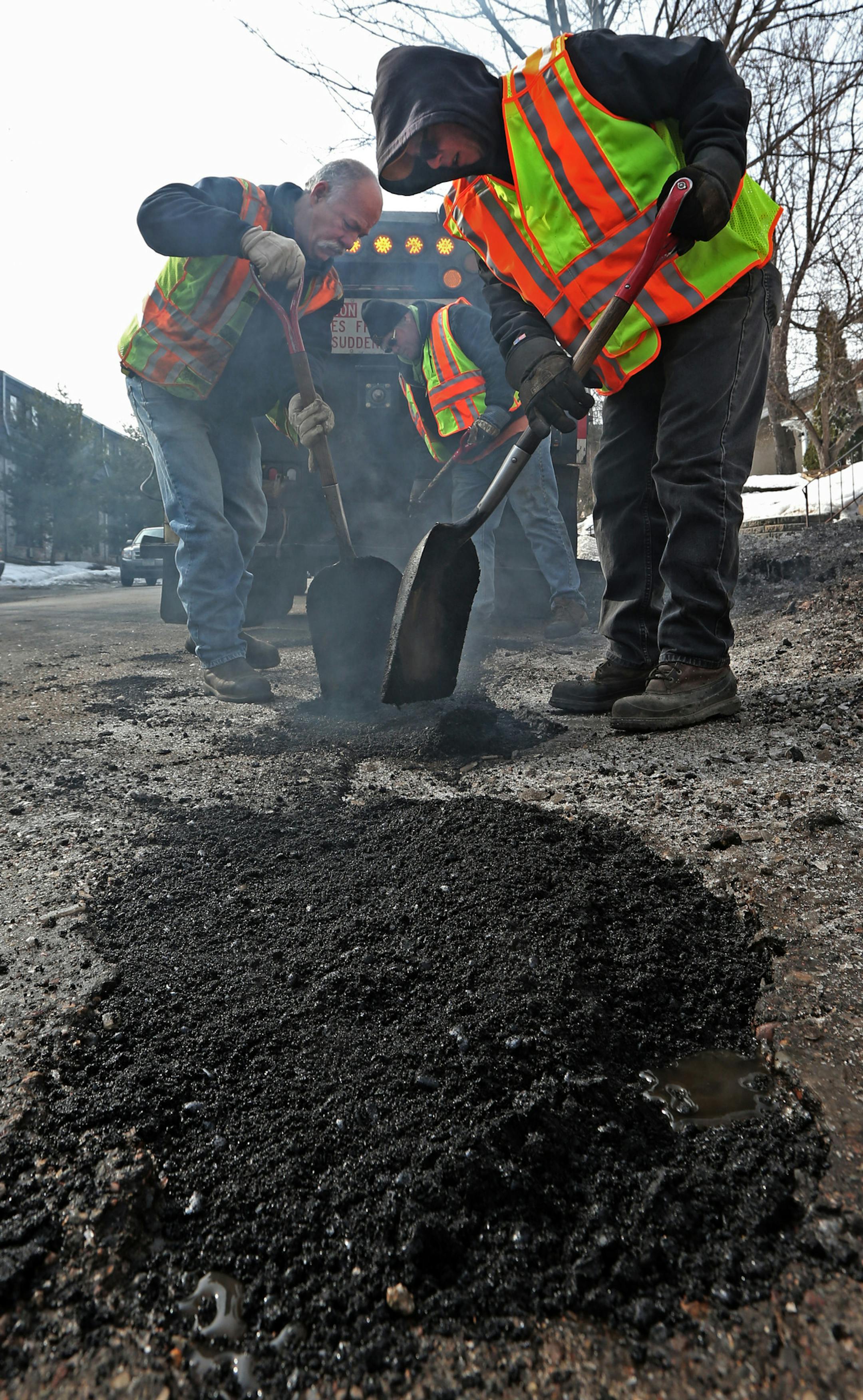 (left to right) Minneapolis city workers Dan Larson, Mike Flaferty and Ben White patched potholes near the intersection of Clinton Ave. and 25th Street in Minneapolis on 3/26/14.] Bruce Bisping/Star Tribune bbisping@startribune.com Dan Larson, Ben White, Mike Flaferty/source.