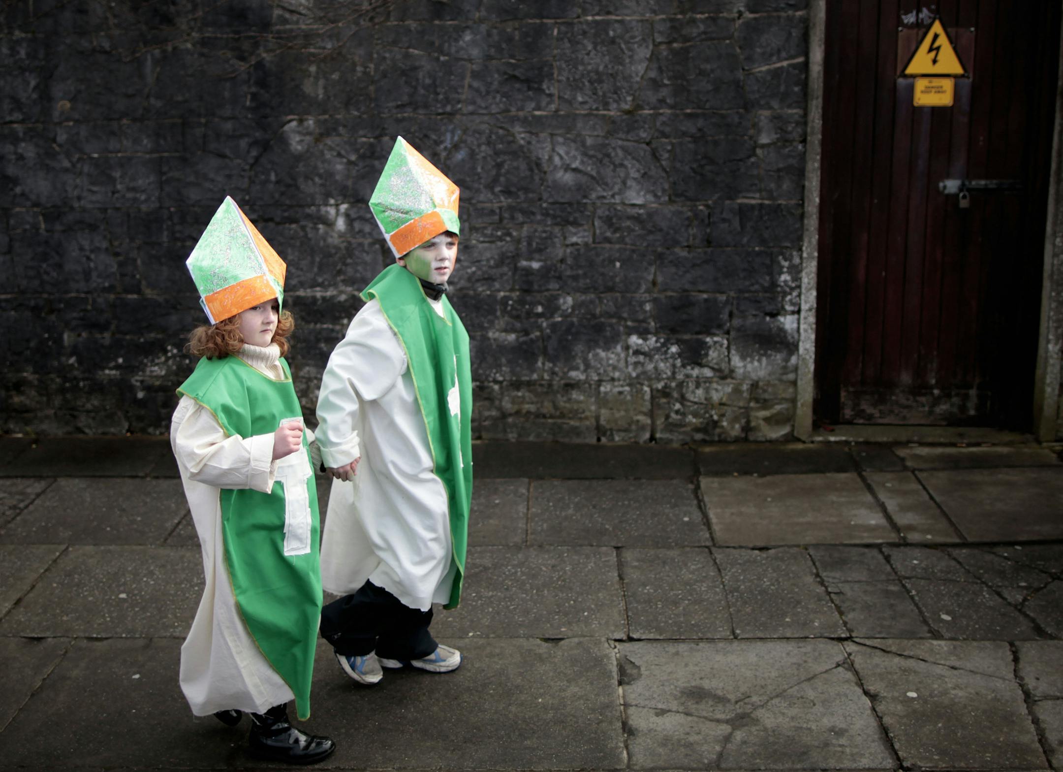 Children make their way to the St Patrick's Day parade during the St Patrick's Day celebrations in Limerick, Ireland, Sunday, March 17, 2013. (AP Photo/Peter Morrison)