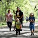 John Big Eagle of Sioux City, IA, rear middle, pushes a stroller with his son Revan Whirlwind, 2, not visible, next to his wife Ka Marie, left, as his