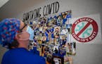 Joe Walker, a critical care nurse with North Memorial Health Hospital, looked over a photo collage commemorating a year of COVID-19 in North Memorial�