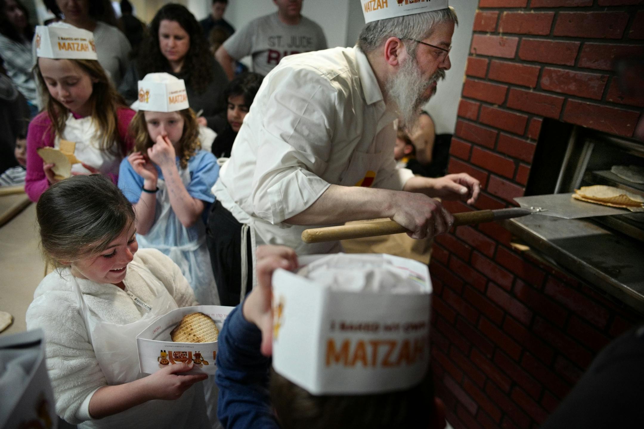 Rabbi Mordechai Grossbaum baked some thinly rolled and perforated dough in the oven. They are ready in less than five minutes.