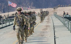 U.S. Army soldiers cross a floating bridge on the Imjin River during a joint river-crossing exercise between South Korea and the United States as a pa
