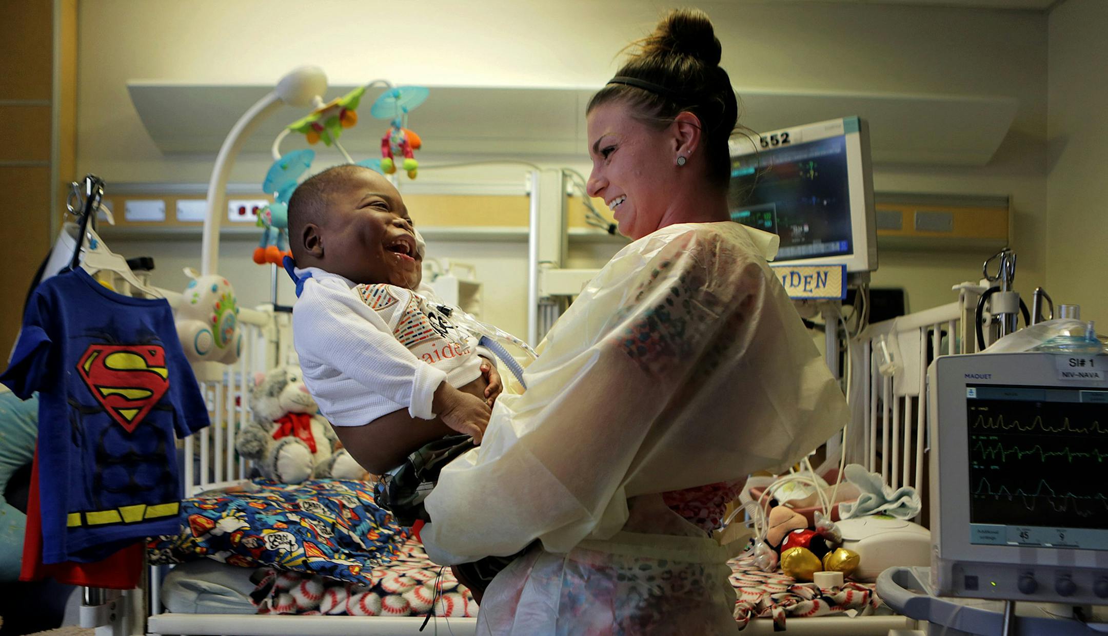 Ke'aiden Proctor plays with his nurse Elizabeth Crank as they get ready for the process of moving him to his second birthday party on Saturday, Nov. 14, 2015 at Children's Hospital in St. Louis. Ke'aiden was born at 27 weeks and has chronic lung disease. He requires around-the-clock care at the neonatal intensive-care unit. (Hy Mach/St. Louis Post-Dispatch/TNS)