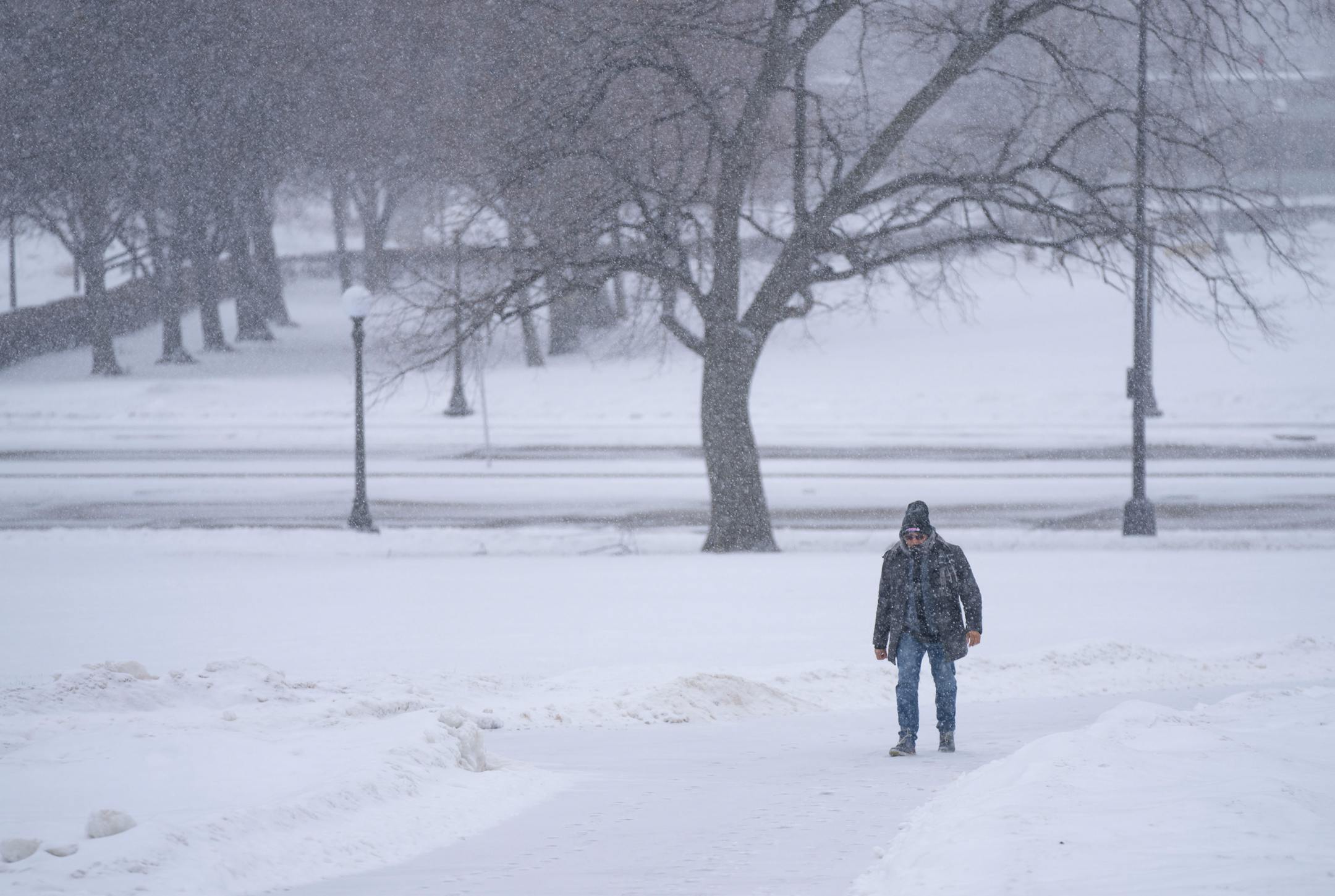 A man walks through the snow Tuesday on the grounds of the Minnesota State Capitol in St. Paul.