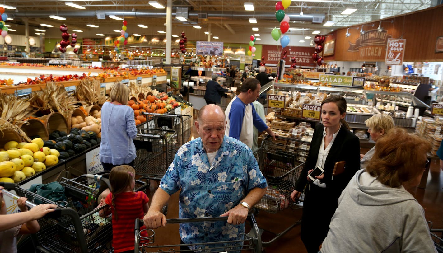 Shoppers looked around at the selection during the grand opening of Fresh Thyme in Bloomington on Wednesday.