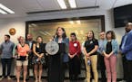 Minneapolis City Council President Lisa Bender, surrounded by renters and tenant advocates, speaks Thursday about a proposed ordinance limiting screen