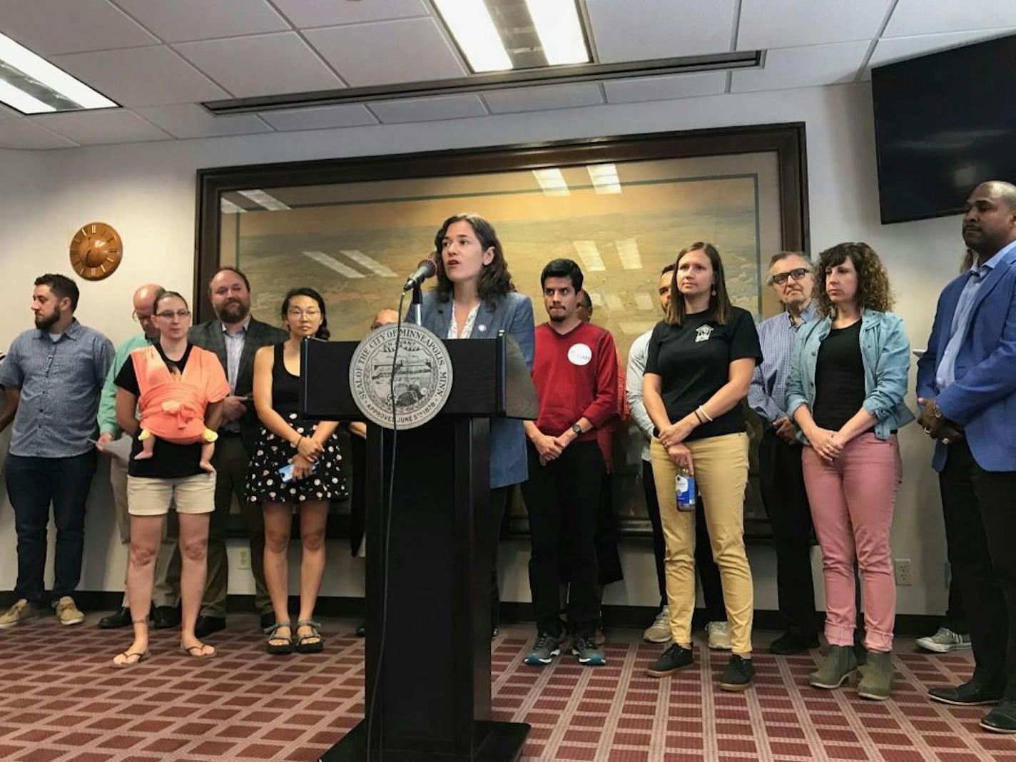 Minneapolis City Council President Lisa Bender, surrounded by renters and tenant advocates, speaks Thursday about a proposed ordinance limiting screening criteria used by landlords for prospective tenants.