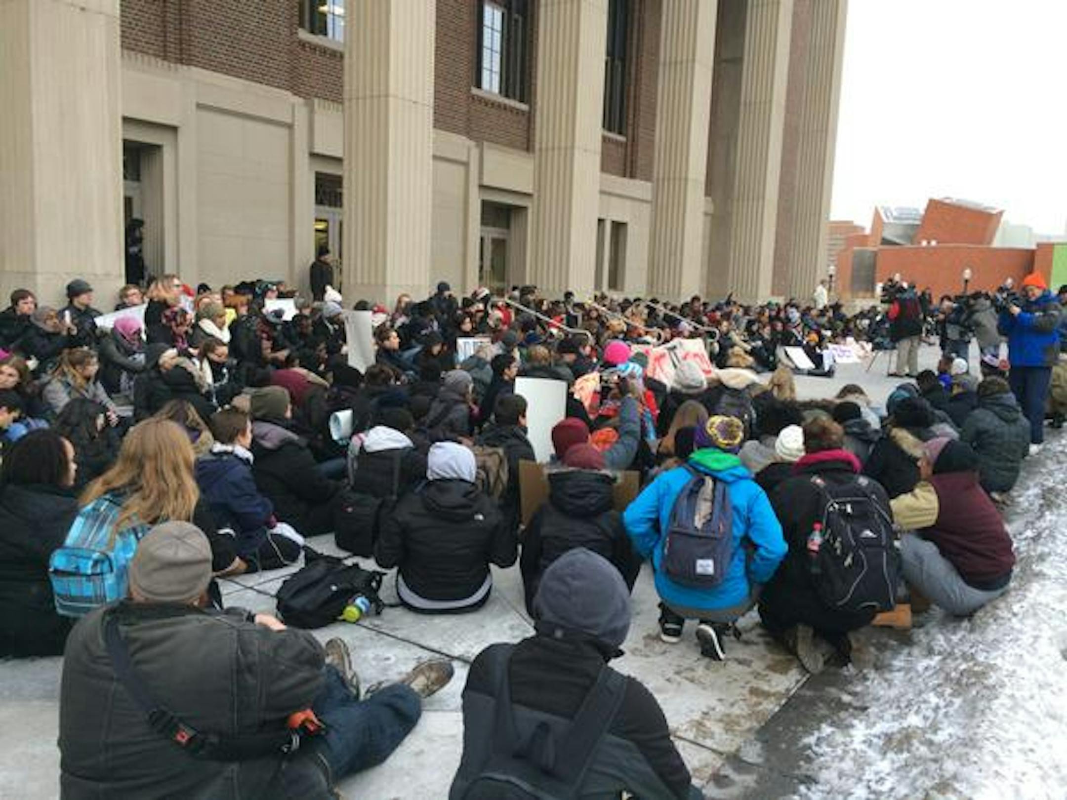 Demonstrators at Coffman Union on the University of Minnesota campus are being instructed to sit for a 4-and-a-half "moment of silence."