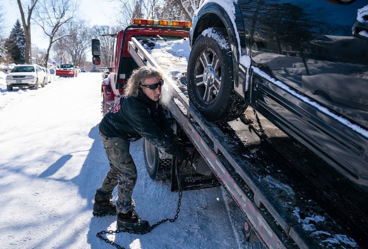 Kerry Brendmoen of Corky's Towing removed a vehicle that was parked on the wrong side of a snow emergency route in south Minneapolis earlier this month.