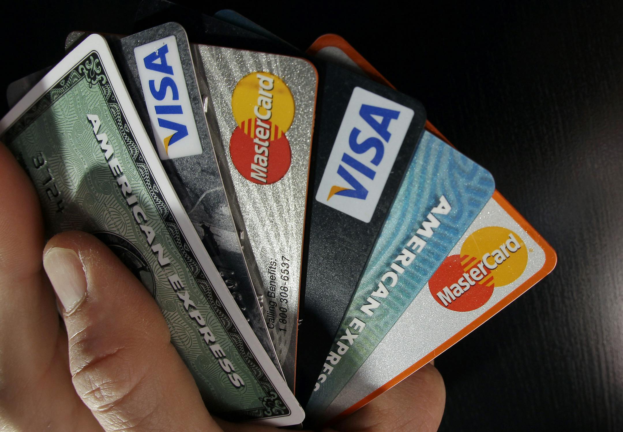 FILE - In this March 5, 2012, file photo, consumer credit cards are posed in North Andover, Mass. Financial experts say paying off debt requires a comprehensive plan. One common strategy is debt consolidation, rolling multiple debts into a single loan or credit card at a lower interest rate. But debt consolidation is not a solution for everyone. (AP Photo/Elise Amendola, File)