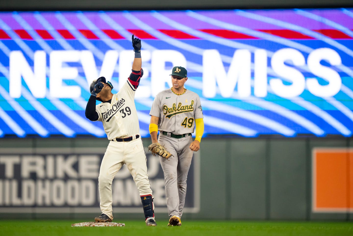 Minnesota Twins third baseman Donovan Solano (39) celebrated his double to right in the eighth inning as Oakland Athletics first baseman Ryan Noda (49) approached. The Minnesota Twins defeated the Oakland Athletics 11-3 in an MLB baseball game Tuesday night, September 26, 2023 at Target Field in Minneapolis. ] JEFF WHEELER • jeff.wheeler@startribune.com