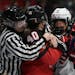 Officials get their arms around Canada's Blayre Turnbull (40) and United States' Abbey Murphy (37) during a shoving match in the first period of a hoc