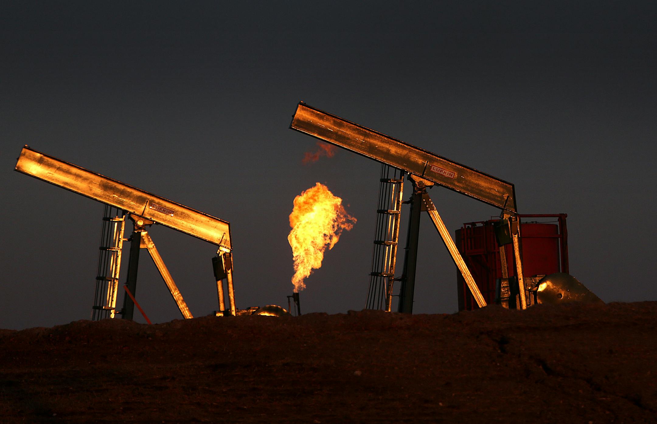 Excess natural gas is burned off at well sites, as seen at a well east of Williston, ND, in the heart of the Bakken oil region. It is hoped that the installation of pipelines will ultimately allow the gas to be contained and utilized. ] (JIM GEHRZ/STAR TRIBUNE) / May 2, 2013 / 12:00 PM Williston, ND and region √ê BACKGROUND INFORMATIN-According to the latest U. S. Geological Survey estimate, there are 7.4 billion barrels of recoverable oil in Western North Dakota and Montana, more th