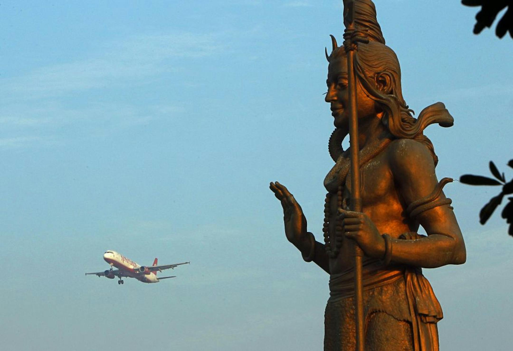 A statue of the Hindu god Shiva stood in the foreground as a Kingfisher Airlines flight approached the New Delhi airport. Kingfisher, owned by brewery tycoon Vijay Mallya, is close to bankruptcy.