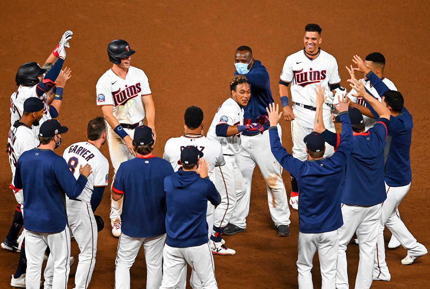 Teammates celebrated a walk-off RBI hit by Minnesota Twins shortstop Jorge Polanco (11) in the bottom of the 12th inning against the Milwaukee Brewers.